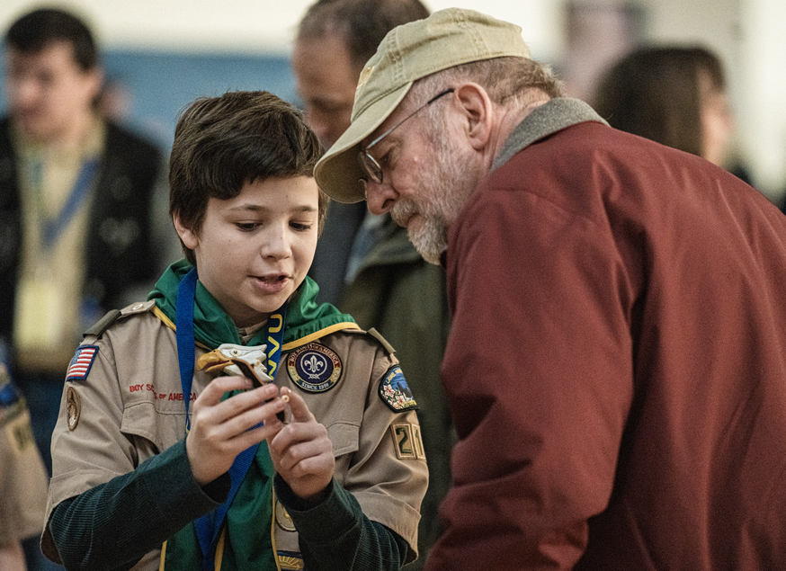 photo of scout showing BSA patch to their parent 