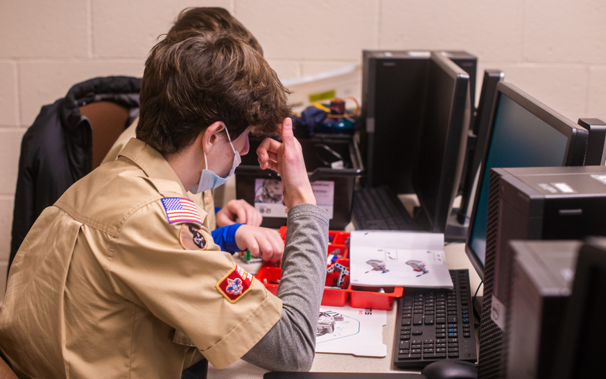scouts working as a team to complete robotics merit badge 