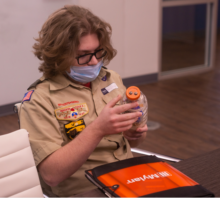 scout examining display during sustainability merit badge 